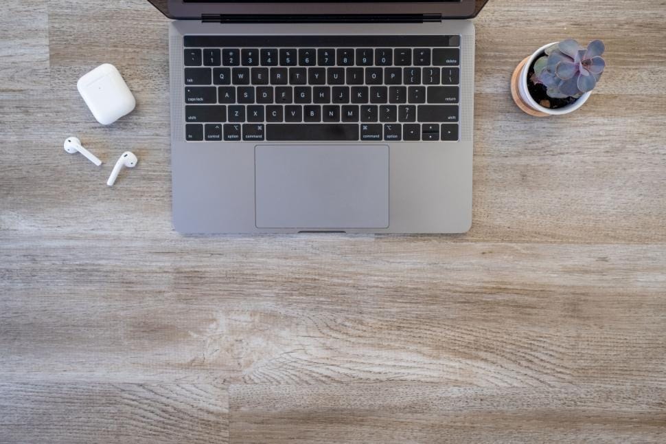 Flat lay of minimalist desk with organized cables and stationery