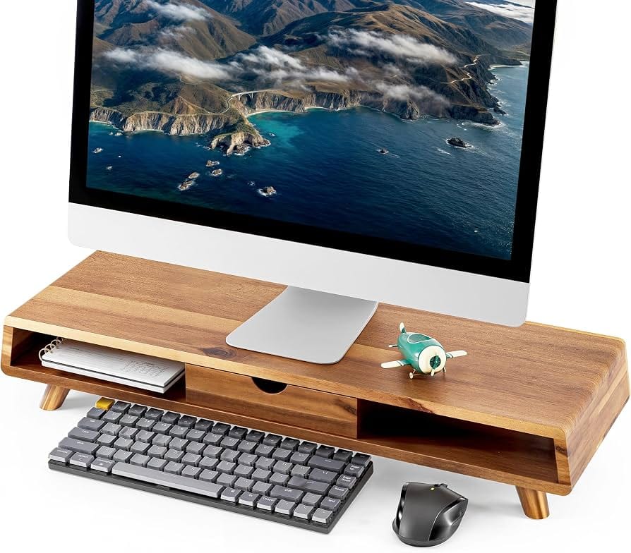Acacia wood monitor stand with storage drawer on a minimalist desk
